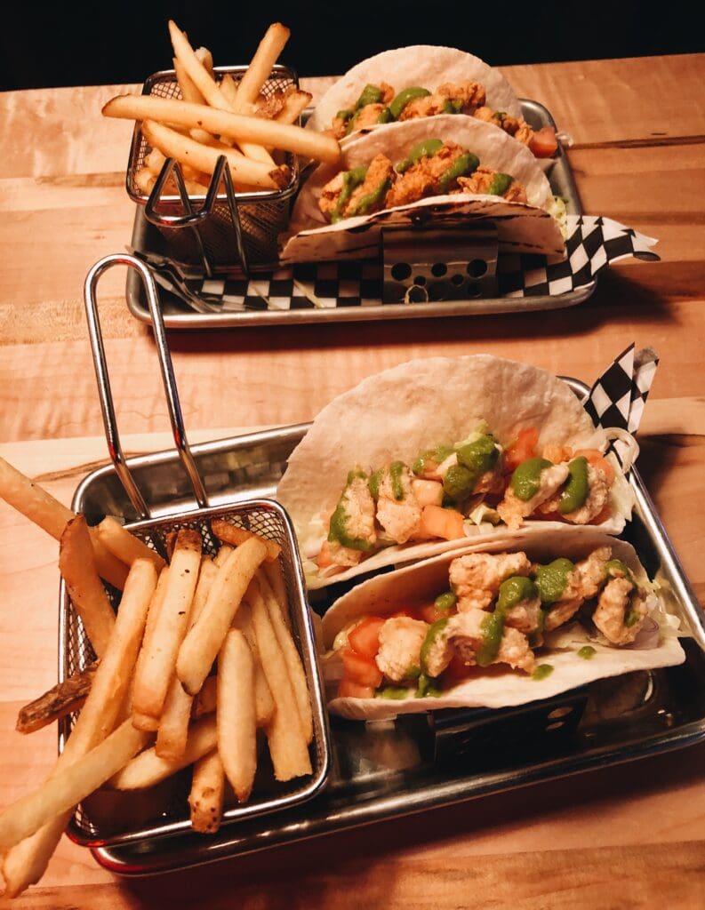Budget-friendly bites from The Roxbury consisting of tacos and fries.