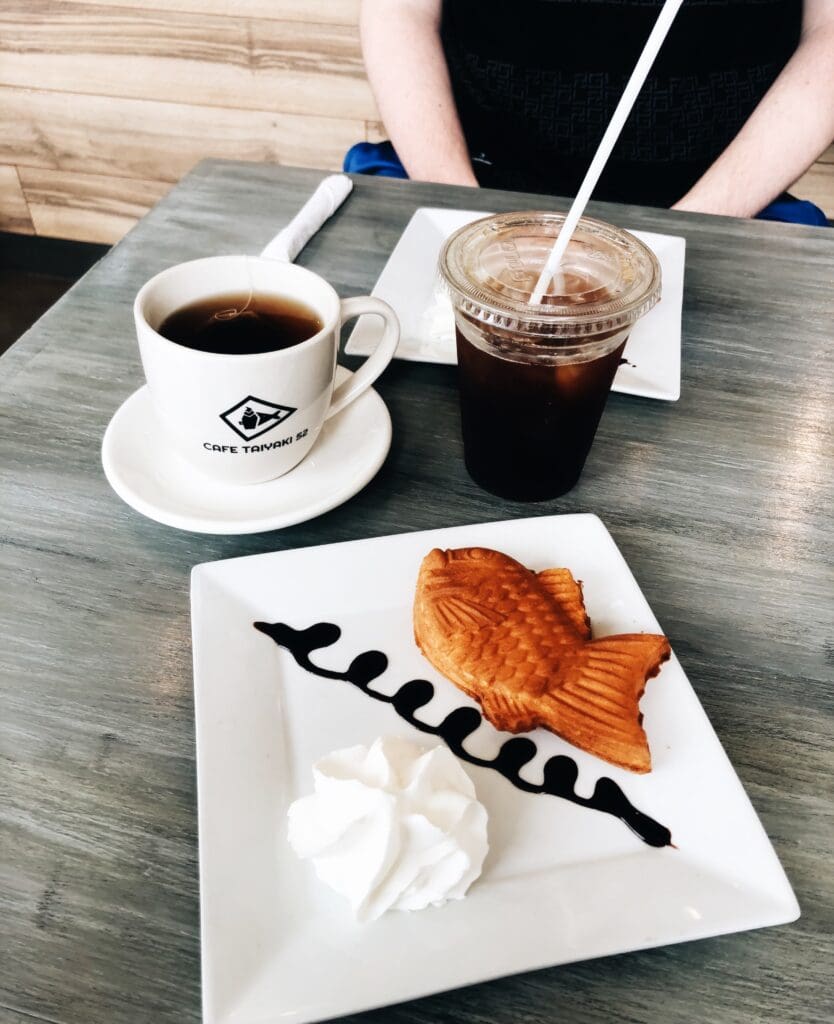 A single Taiyaki pictured with coffee.