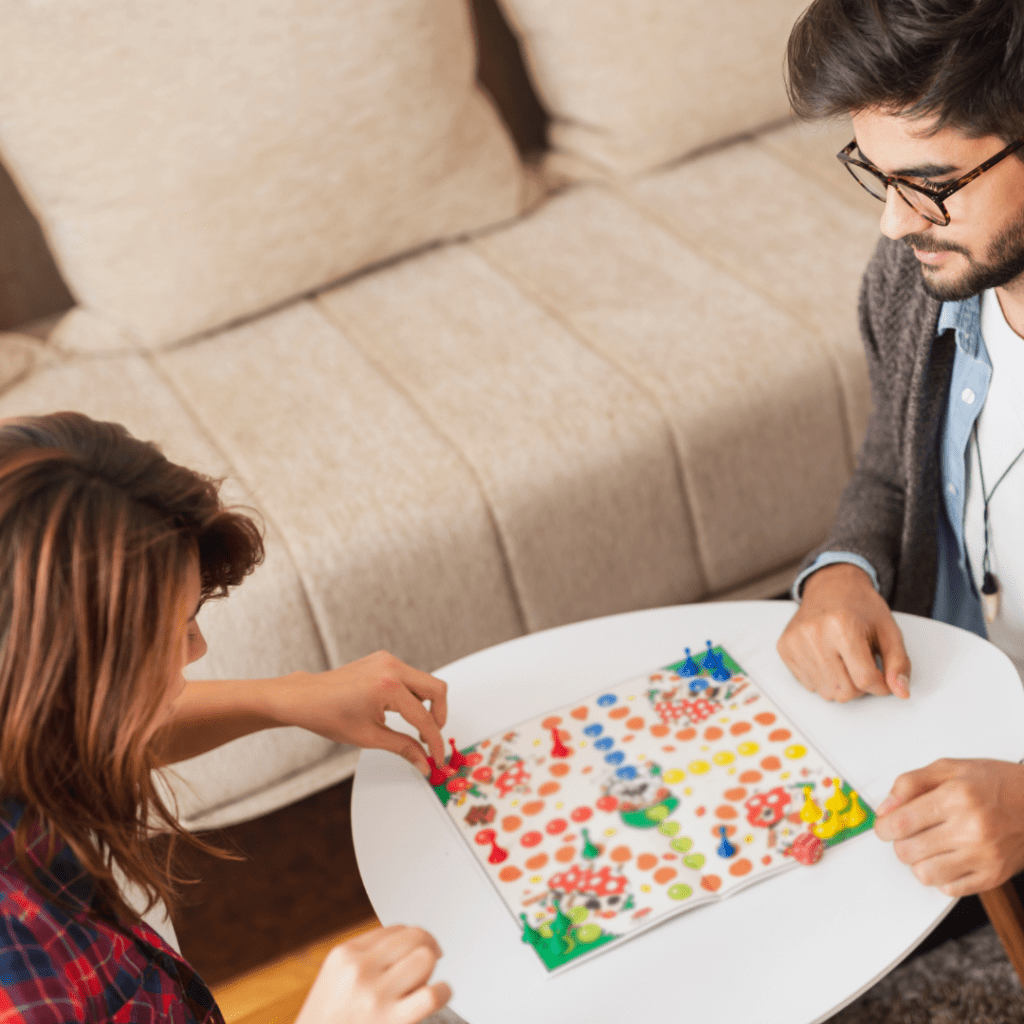 A man and a woman playing a board game together for date night.