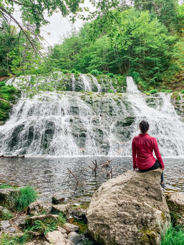 Woman pictured in front of Egypt Falls in Cape Breton, Nova Scotia - a place within the province residents can now travel to as part of Nova Scotia's Reopening Plan.