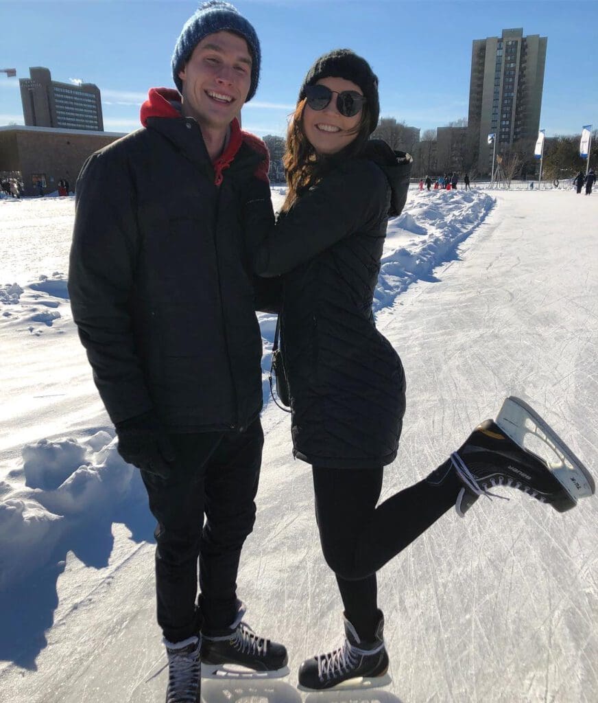 A man and woman smiling while skating at the Emera Oval - a top active date idea spot in Halifax.