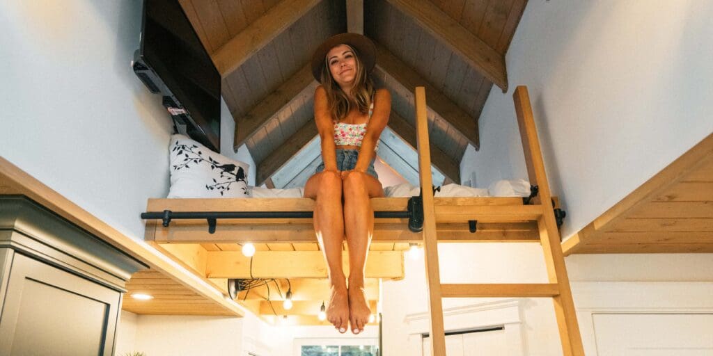 Stay in a treehouse. A girl sitting in a loft bed. Stay in a tree house out in Chilliwack, BC