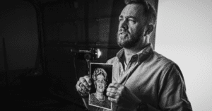 Man holding image of holocaust survivor relative
