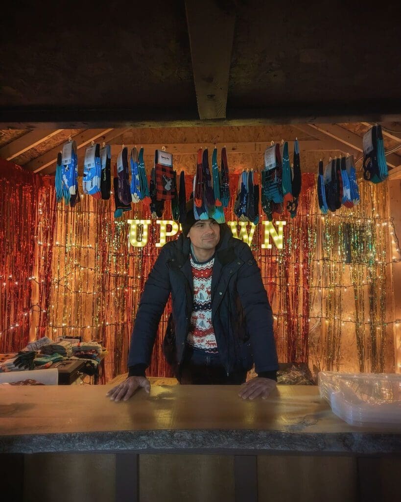 A photograph of the Uptown Sox vendor booth at the Ottawa Christmas Market.