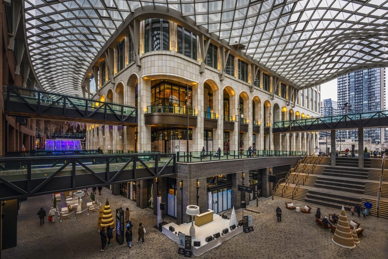 inside The Well Toronto. Featuring its architecture, arhced doorways and windows with a net glass ceiling