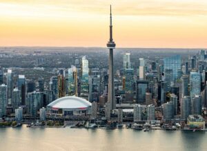 Roges stadium and the Cn Tower Toronto Skyline with a sunset backdrop.