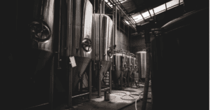 silver brewery kegs in a dark room