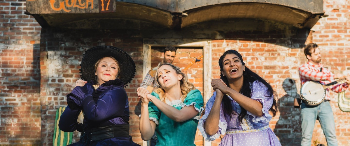 Three Shakespeare By The Sea performers acting out a scene.