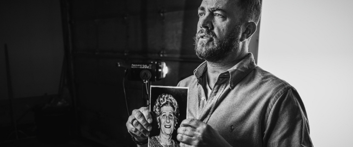 Man holding image of holocaust survivor relative