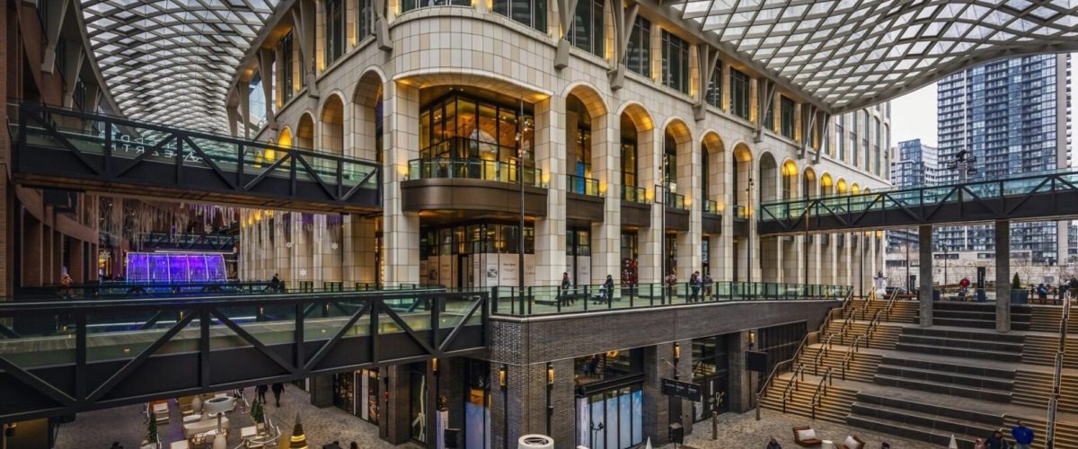 inside The Well Toronto. Featuring its architecture, arhced doorways and windows with a net glass ceiling