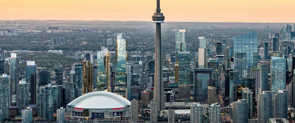 Roges stadium and the Cn Tower Toronto Skyline with a sunset backdrop.