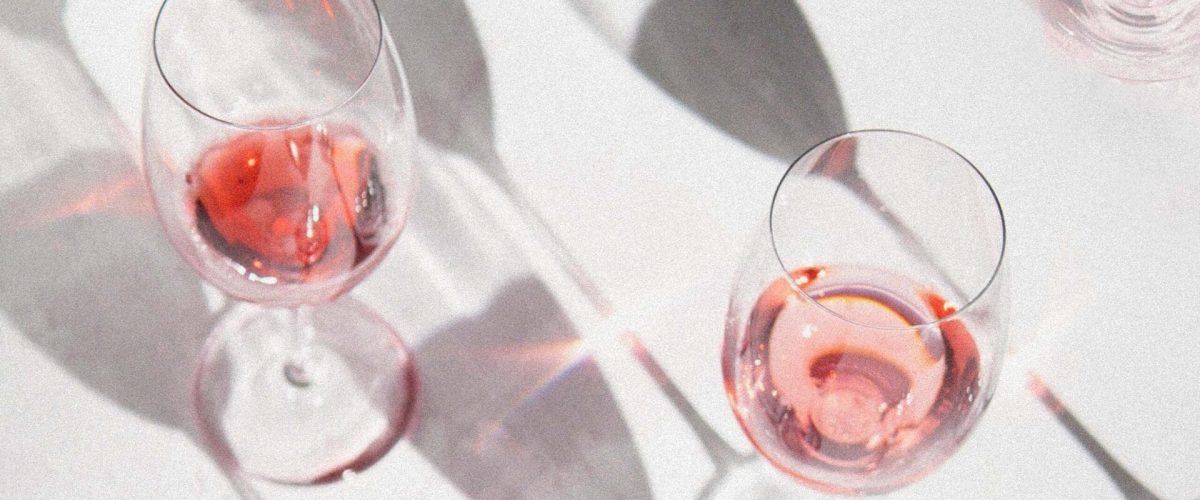 A day at the wineries in Langley BC. It is a white back ground with tall wine glasses filled with rose.