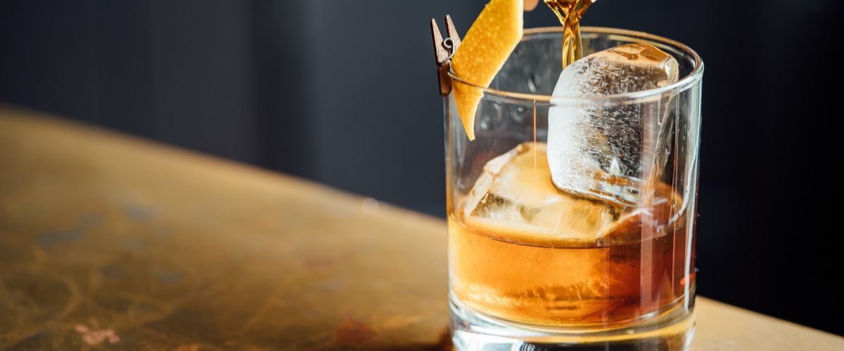 cocktail being poured on bar top